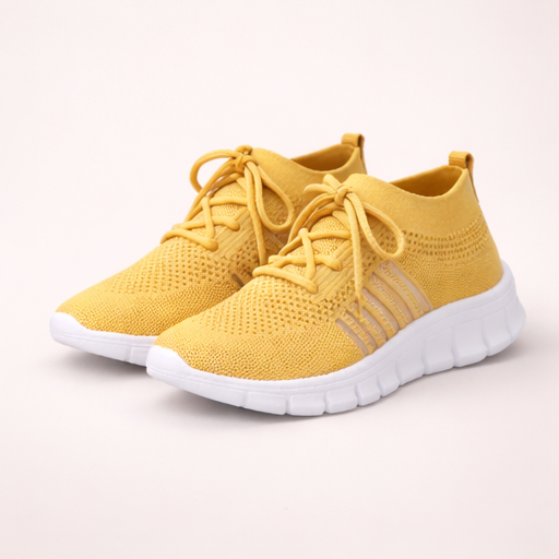 Yellow sneakers with white soles on a light gray background